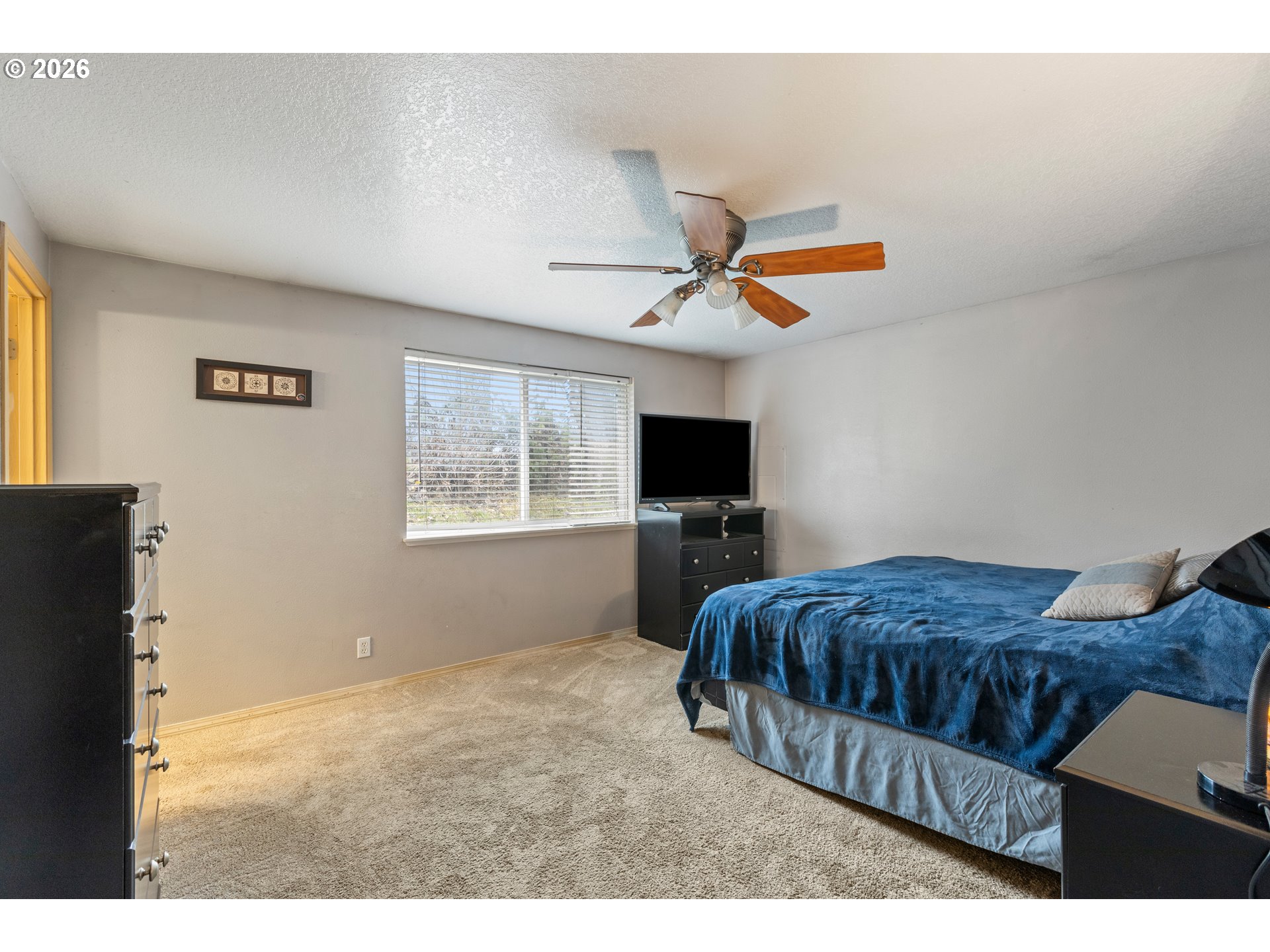 220 Southeast Wells Road Oakland, OR 97462 - Photo 27 of 45 a living room with a bed furniture and a flat screen tv
