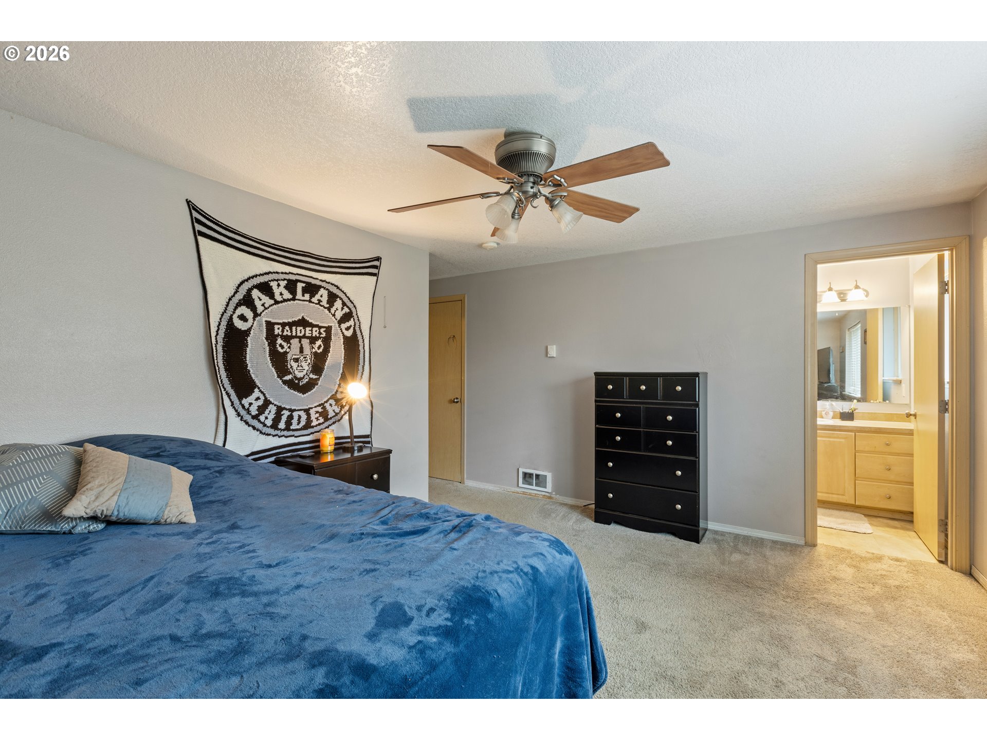220 Southeast Wells Road Oakland, OR 97462 - Photo 29 of 45 a bedroom with a bed and a chandelier