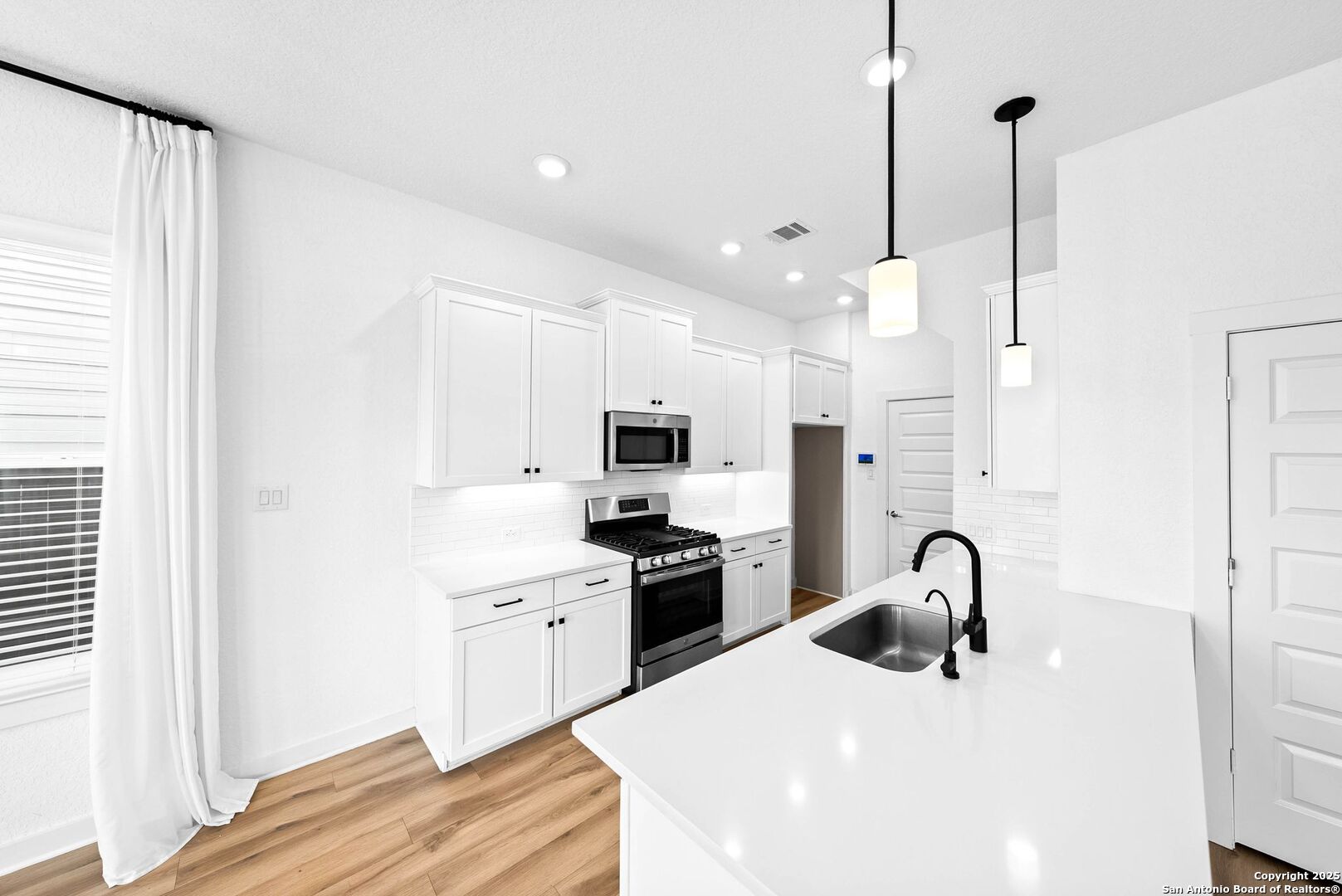 5843 Whitby Road, Unit 3 San Antonio, TX 78240 - Photo 13 of 37 a kitchen with stainless steel appliances kitchen island a sink a stove and refrigerator