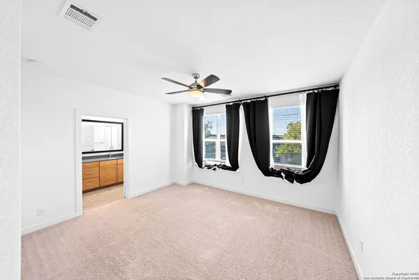 a view of a room with wooden floor and a window