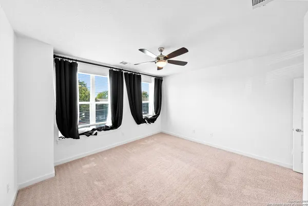 an empty room with windows and closet