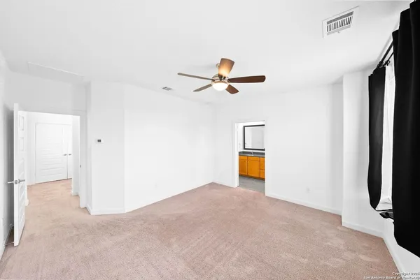 a view of a livingroom with a ceiling fan and wooden floor