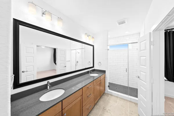 a bathroom with 2 sink and a mirror