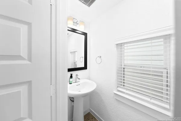 a bathroom with a sink a mirror and a shower