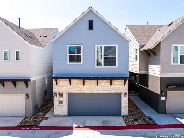 a view of a house with a garage and balcony