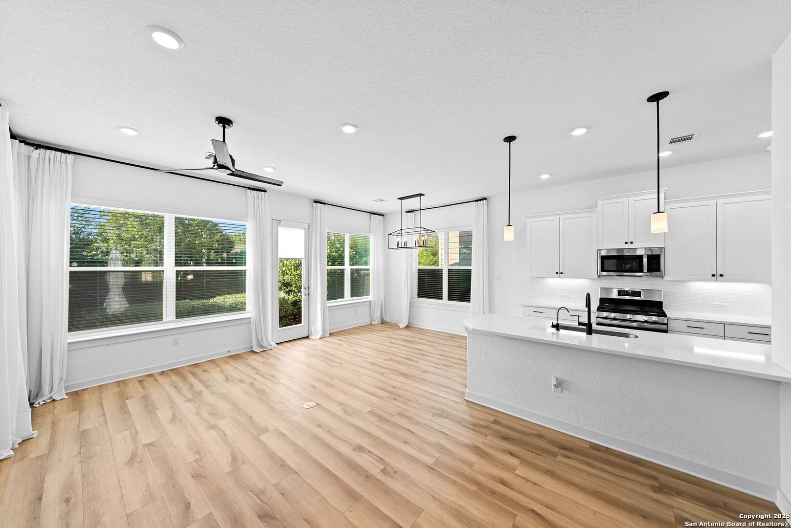 5843 Whitby Road, Unit 3 San Antonio, TX 78240 - Photo 7 of 37 a large kitchen with stainless steel appliances a large window a oven a counter space and a window