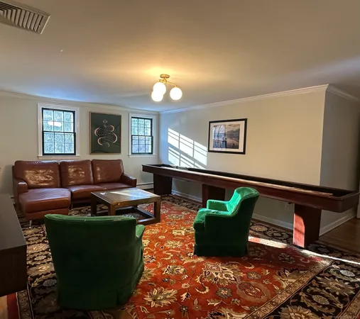 a living room with furniture lamp and window