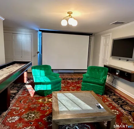 a room with pool table and flat screen tv