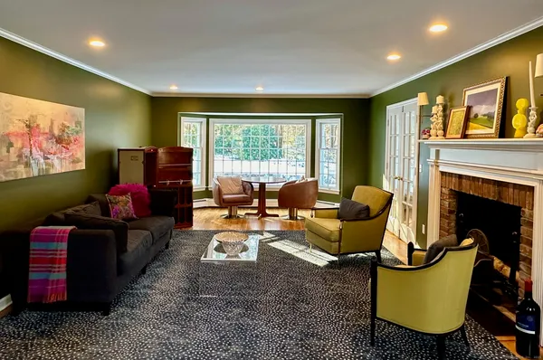 a living room with fireplace furniture and a flat screen tv