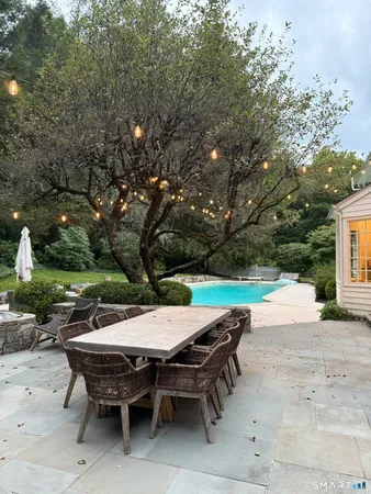 a house view with a sitting space fire pit and outdoor space