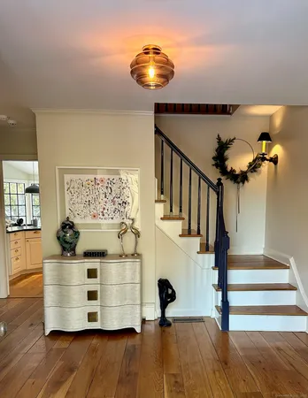 a view of entryway livingroom and hall with wooden floor