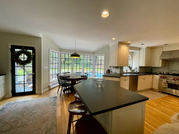 a view of a kitchen with kitchen island a sink a counter and a window