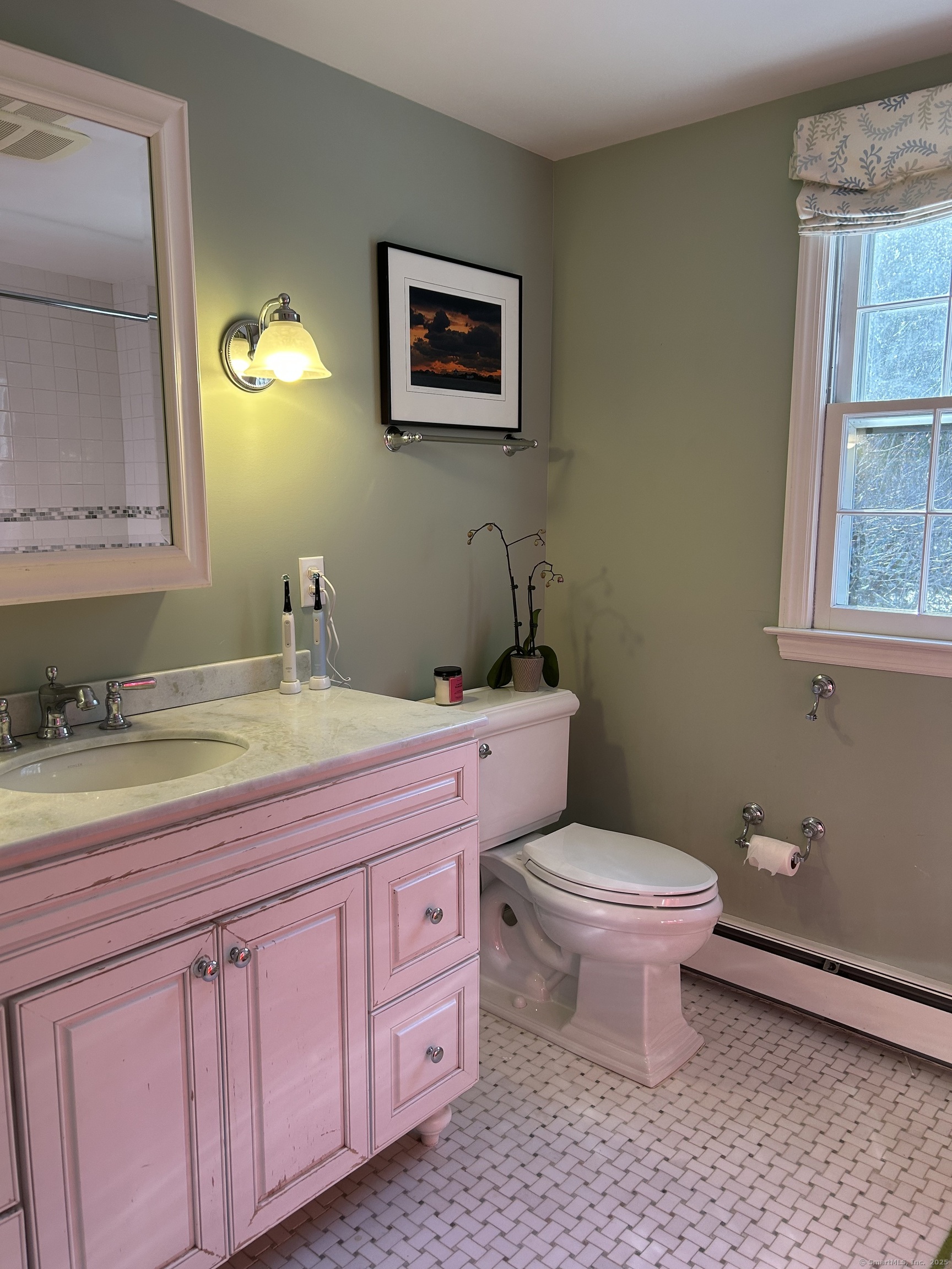 25 Deacons Lane Wilton, CT 06897 - Photo 26 of 37 a bathroom with a granite countertop toilet a sink and a mirror