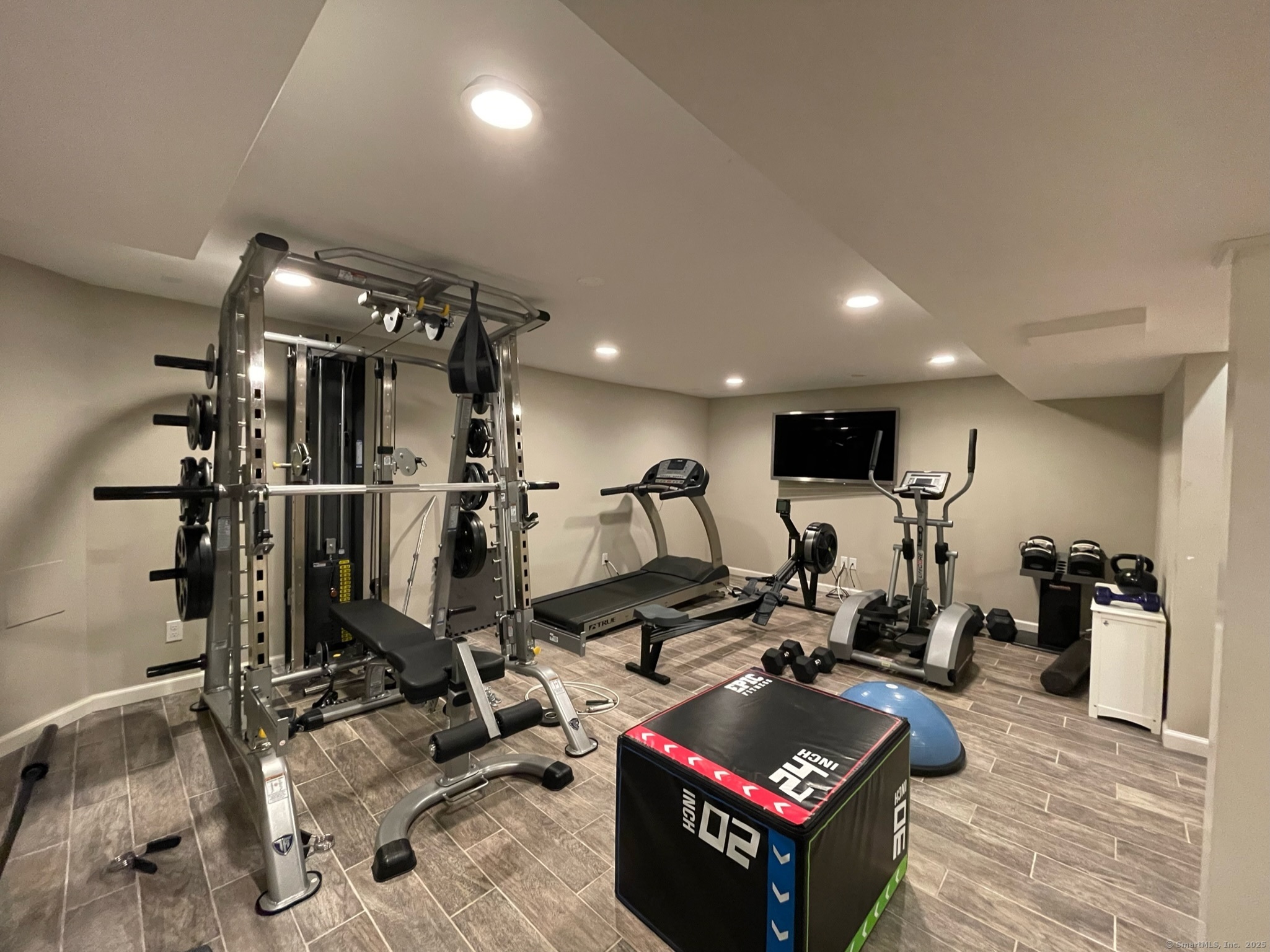 25 Deacons Lane Wilton, CT 06897 - Photo 32 of 37 a room with gym equipment and mirror