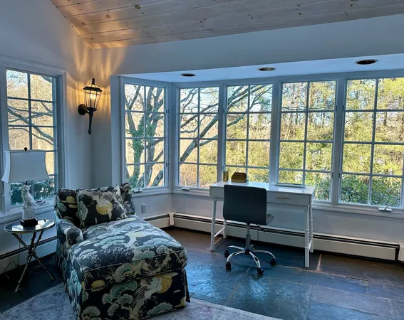 a bedroom with furniture and a window