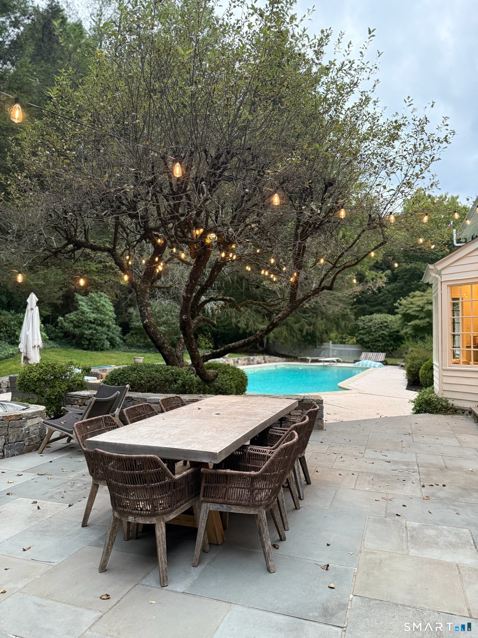 25 Deacons Lane Wilton, CT 06897 - Photo 4 of 37 an outdoor space with furniture and umbrella