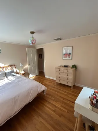 a spacious bedroom with a bed and a desk