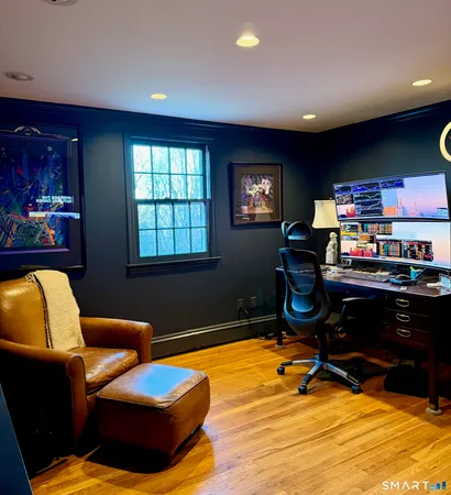 a livingroom with workspace and a window