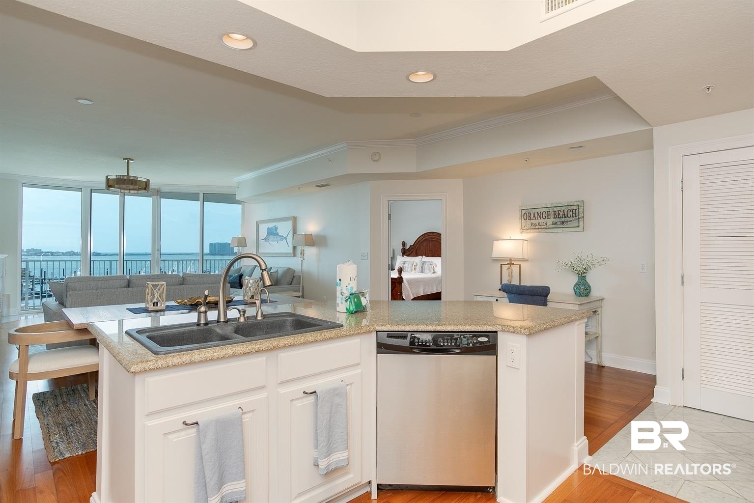 27800 Canal Road, Unit 411 Orange Beach, AL 36561 - Photo 11 of 49 Kitchen island with granite countertop, double basin sink, and stainless steel dishwasher