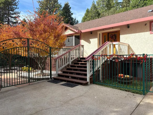 a view of a house with a wooden deck