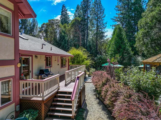 a backyard of a house with barbeque oven table and chairs