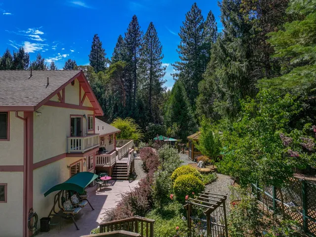 a view of a chair and table in backyard of the house