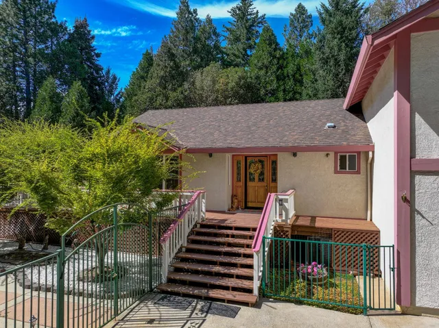 a view of a patio with chairs and potted plants