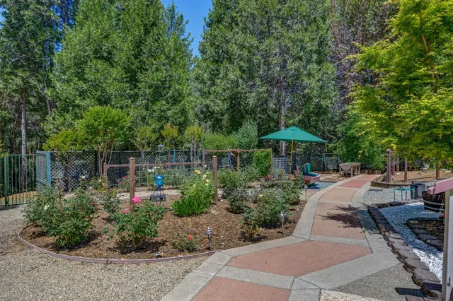 a kitchen with stainless steel appliances granite countertop a stove refrigerator and a view of living room