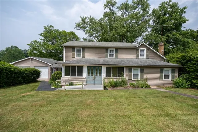 a front view of a house with a garden