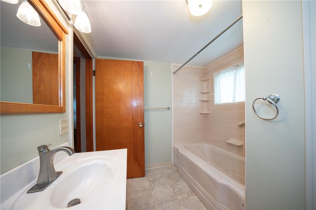 1539 Dime Road Vandergrift, PA 15690 - Photo 15 of 27 a bathroom with a tub a sink and a large mirror