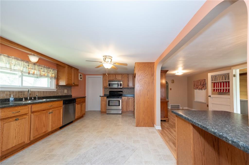 1539 Dime Road Vandergrift, PA 15690 - Photo 3 of 27 a large kitchen with granite countertop a large counter top cabinets and stainless steel appliances