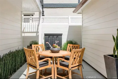 a view of a patio with a table and chairs