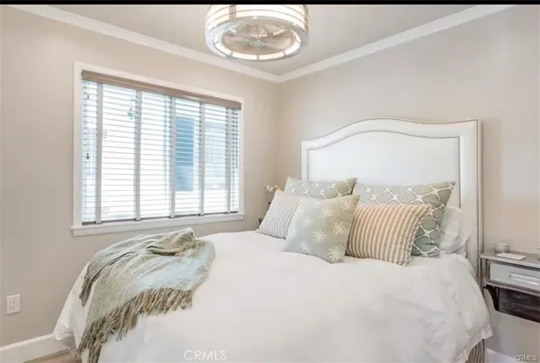 a bedroom with a bed and a large mirror