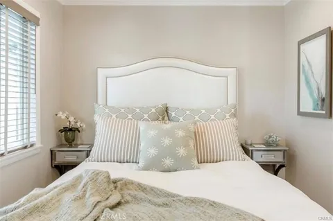 a bedroom with a bed and a mirror