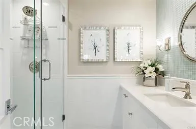 a bathroom with a shower sink and mirror