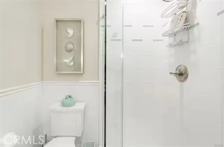 a bathroom with a toilet and shower