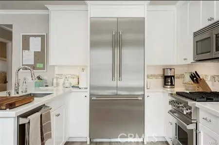 a kitchen with a refrigerator sink and cabinets