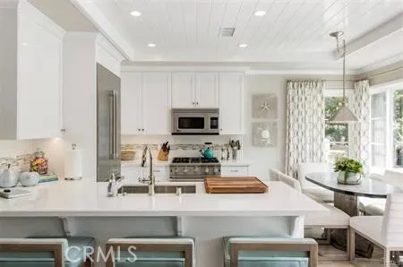 a kitchen with stainless steel appliances kitchen island granite countertop a sink and cabinets