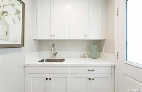 a kitchen with a sink and cabinets