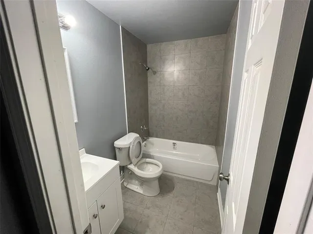 a white toilet sitting next to a sink
