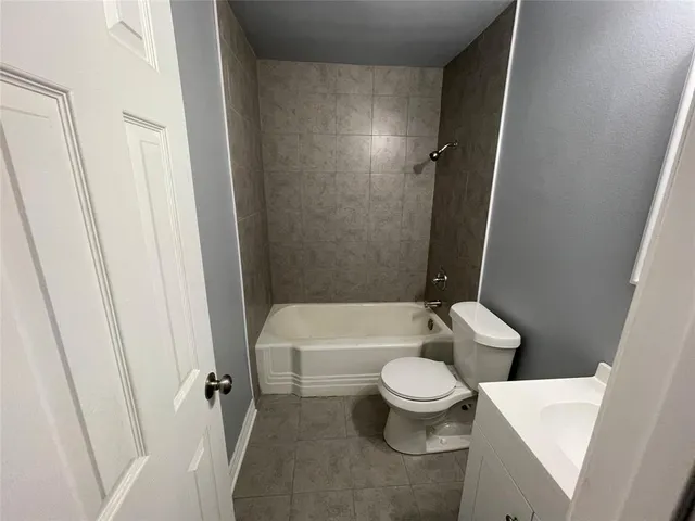 a bathroom with a toilet and a tub