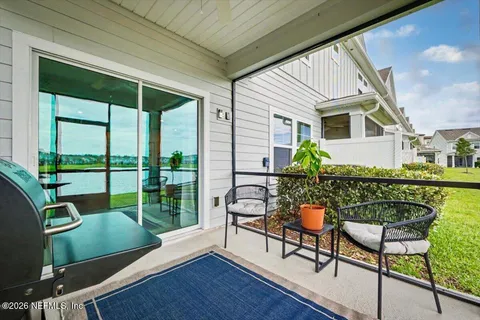 a roof deck with table and chairs and wooden floor