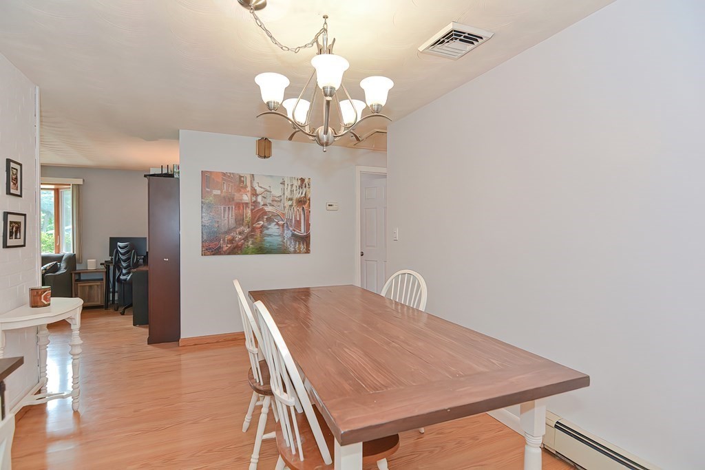 2 Temi Road Framingham, MA 01701 - Photo 11 of 34 a dining room with wooden floor a chandelier a wooden table and chairs