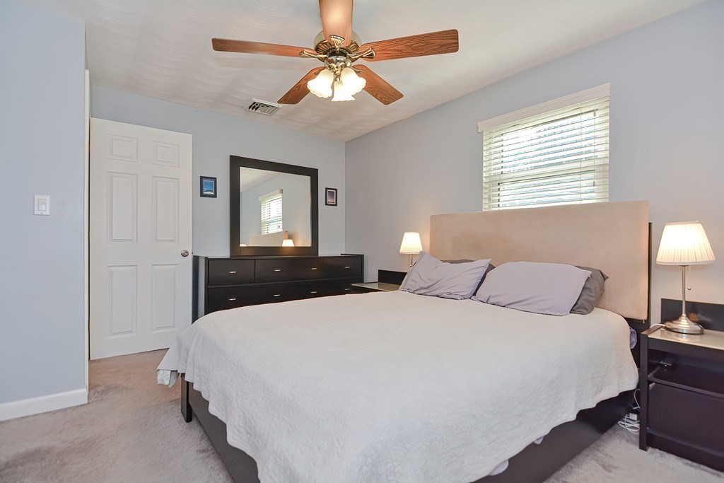 2 Temi Road Framingham, MA 01701 - Photo 17 of 34 a room with a bed and a chandelier