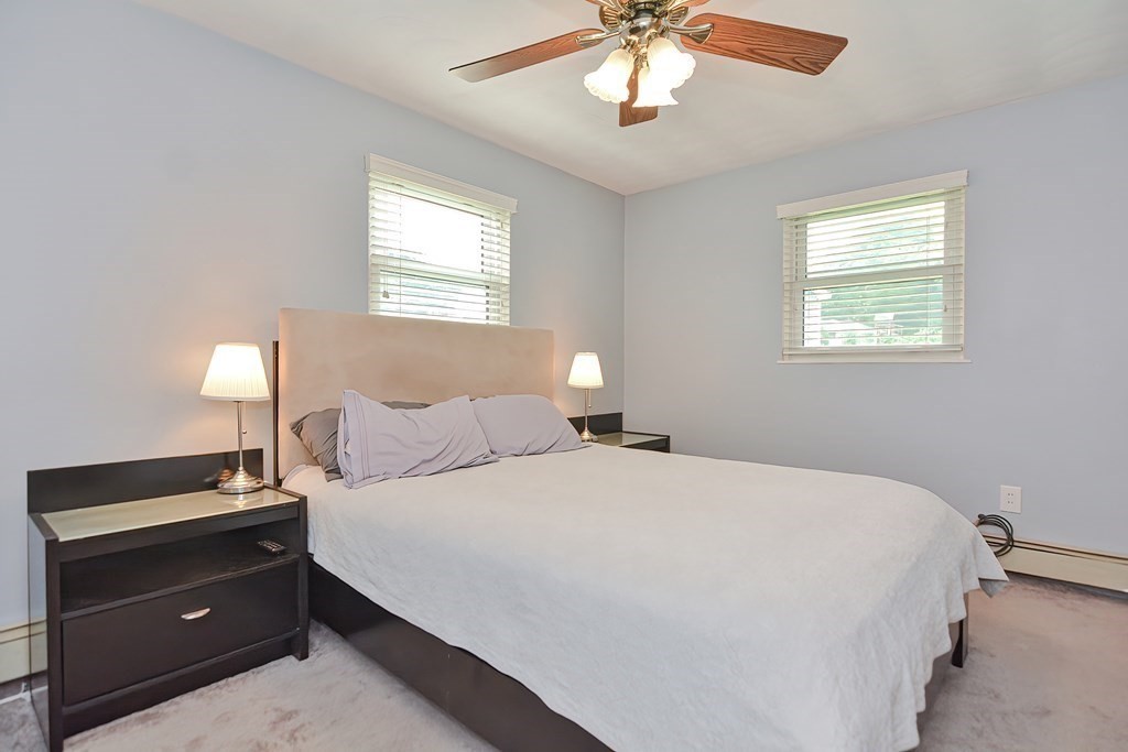 2 Temi Road Framingham, MA 01701 - Photo 18 of 34 a bedroom with a bed and a chandelier