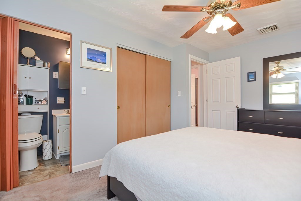 2 Temi Road Framingham, MA 01701 - Photo 19 of 34 a bedroom with a bed and a chandelier