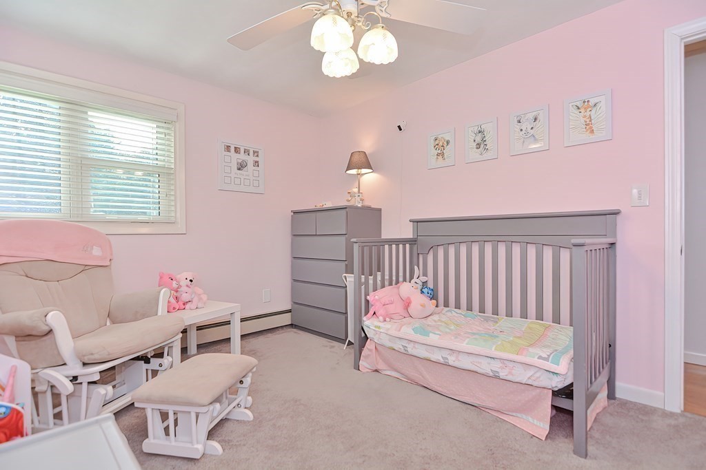 2 Temi Road Framingham, MA 01701 - Photo 20 of 34 a spacious bedroom with a bed and a chandelier