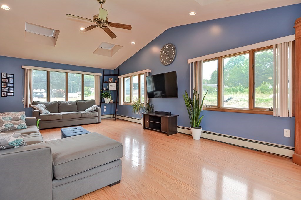 2 Temi Road Framingham, MA 01701 - Photo 2 of 34 a living room with furniture flat screen tv and a fireplace