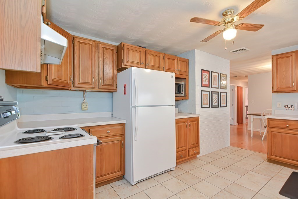 2 Temi Road Framingham, MA 01701 - Photo 7 of 34 a kitchen with stainless steel appliances granite countertop a refrigerator and a stove top oven
