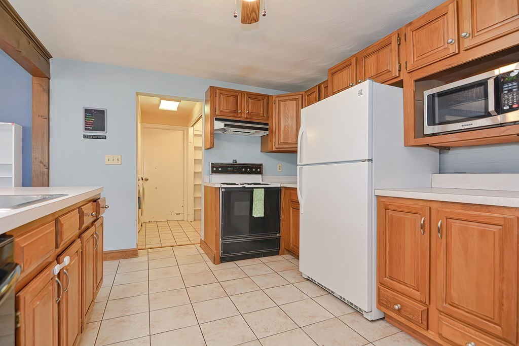 2 Temi Road Framingham, MA 01701 - Photo 8 of 34 a kitchen with stainless steel appliances a refrigerator and a stove top oven